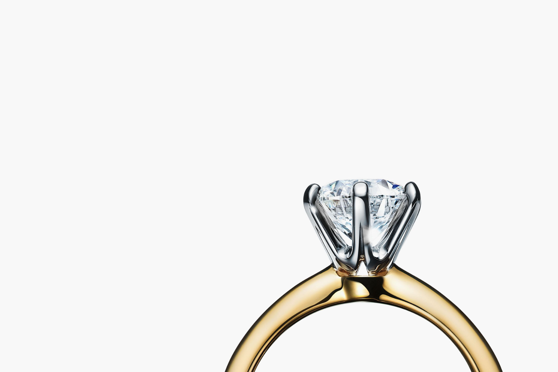 A solitaire ring setting and the ring features a single, sparkling gemstone held in place by a simple and elegant metal band