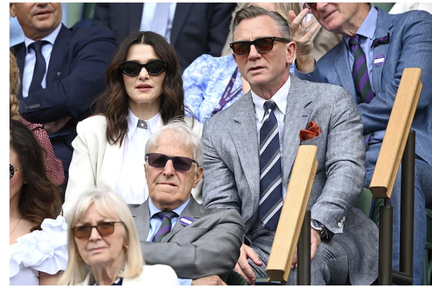 Daniel Craig seated next to his wife, actress Rachel Weisz, wearing an Omega Seamaster Planet Ocean