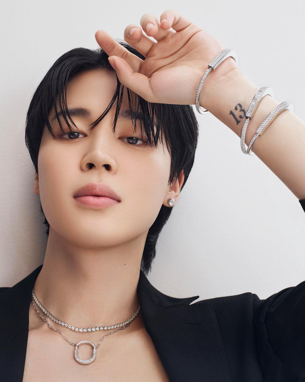BTS Jimin in a black suit wearing the Tiffany Lock Collection.