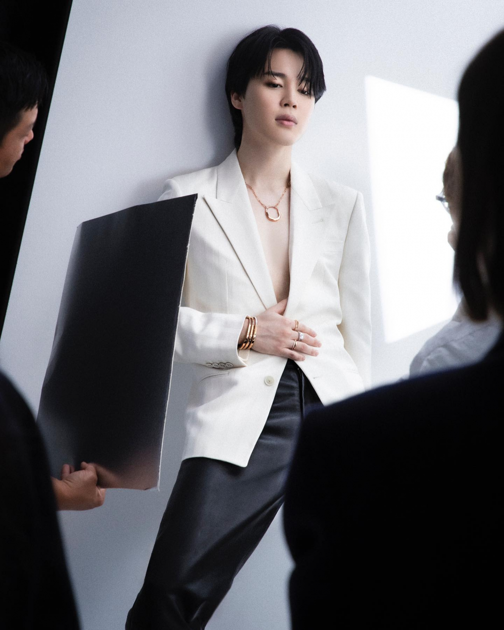 BTS Jimin wearing a white suit and Tiffany & Co jewelry.