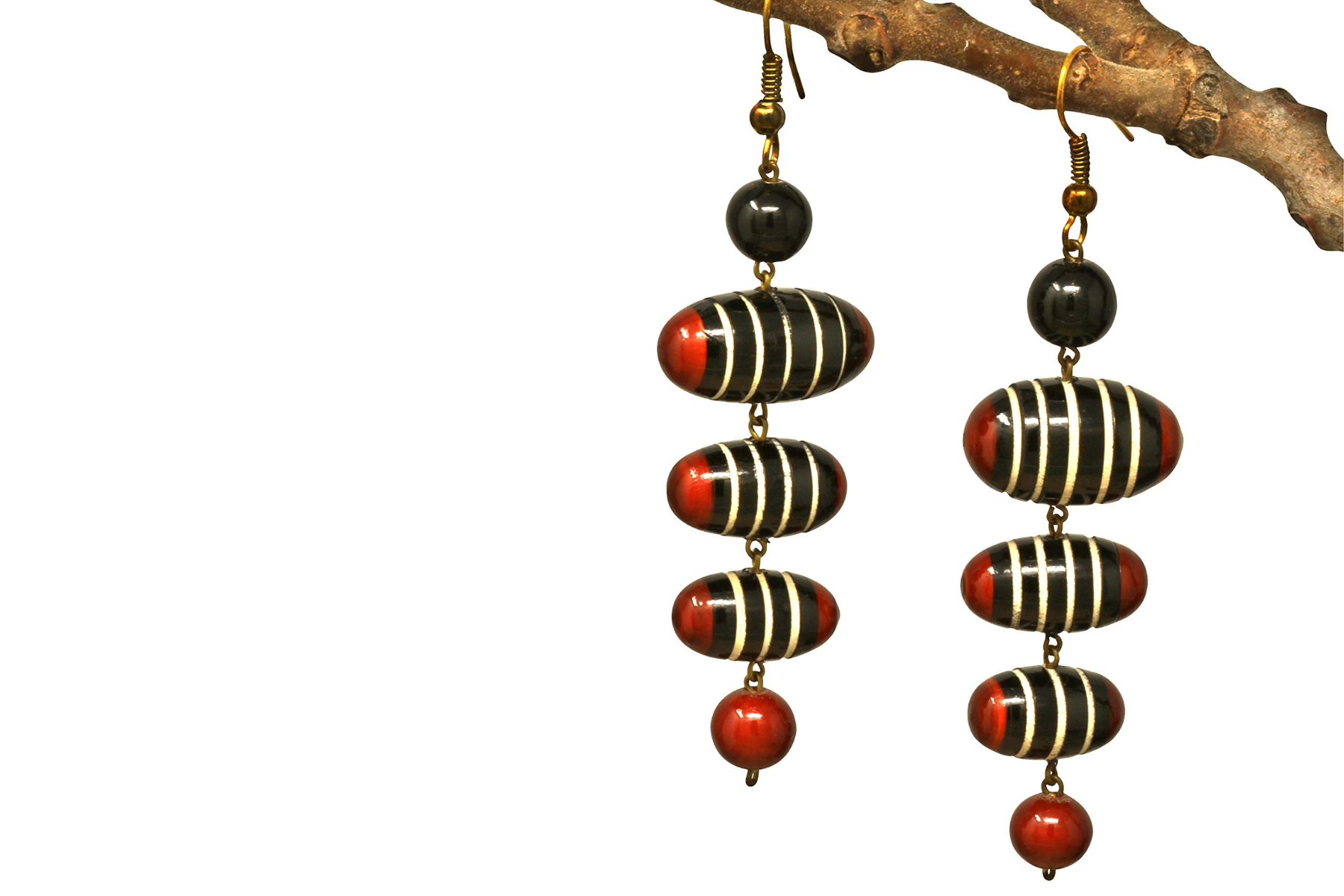 A pair of dangling earrings dangle from a tree part
