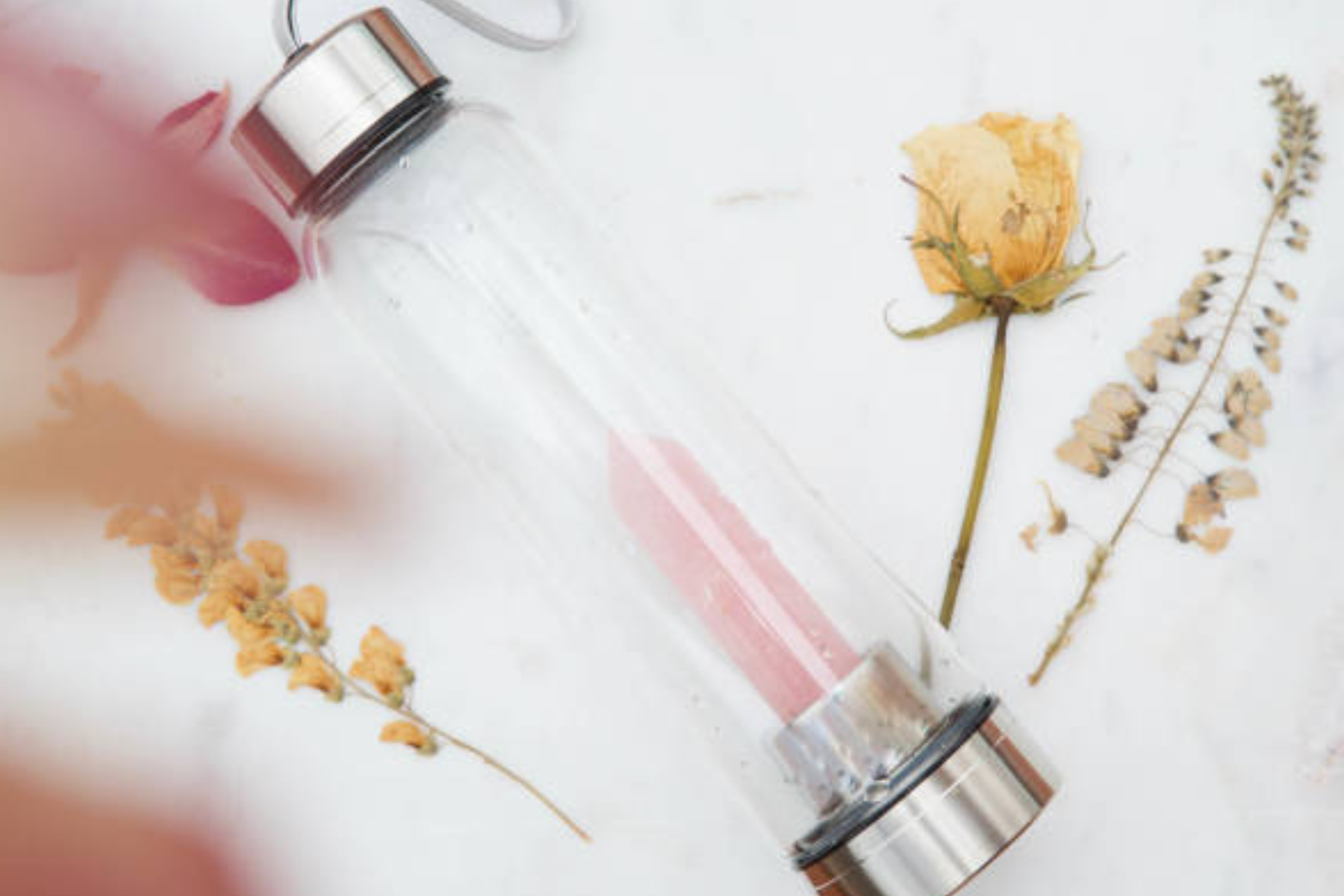 A rose quartz-filled gemstone-infused bottle