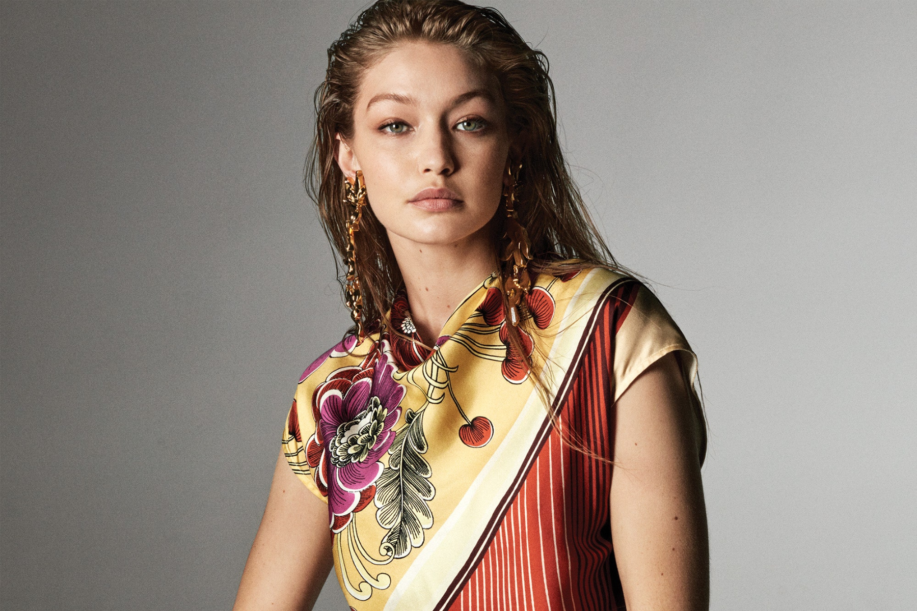 Gigi Hadid is wearing a set of sustainable earrings and a necklace