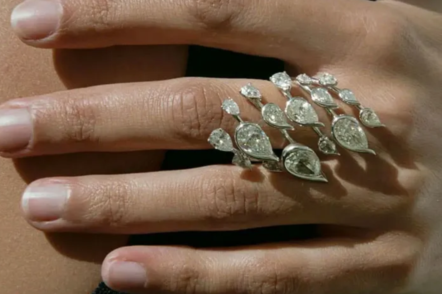A woman wearing a diamond-encrusted ring
