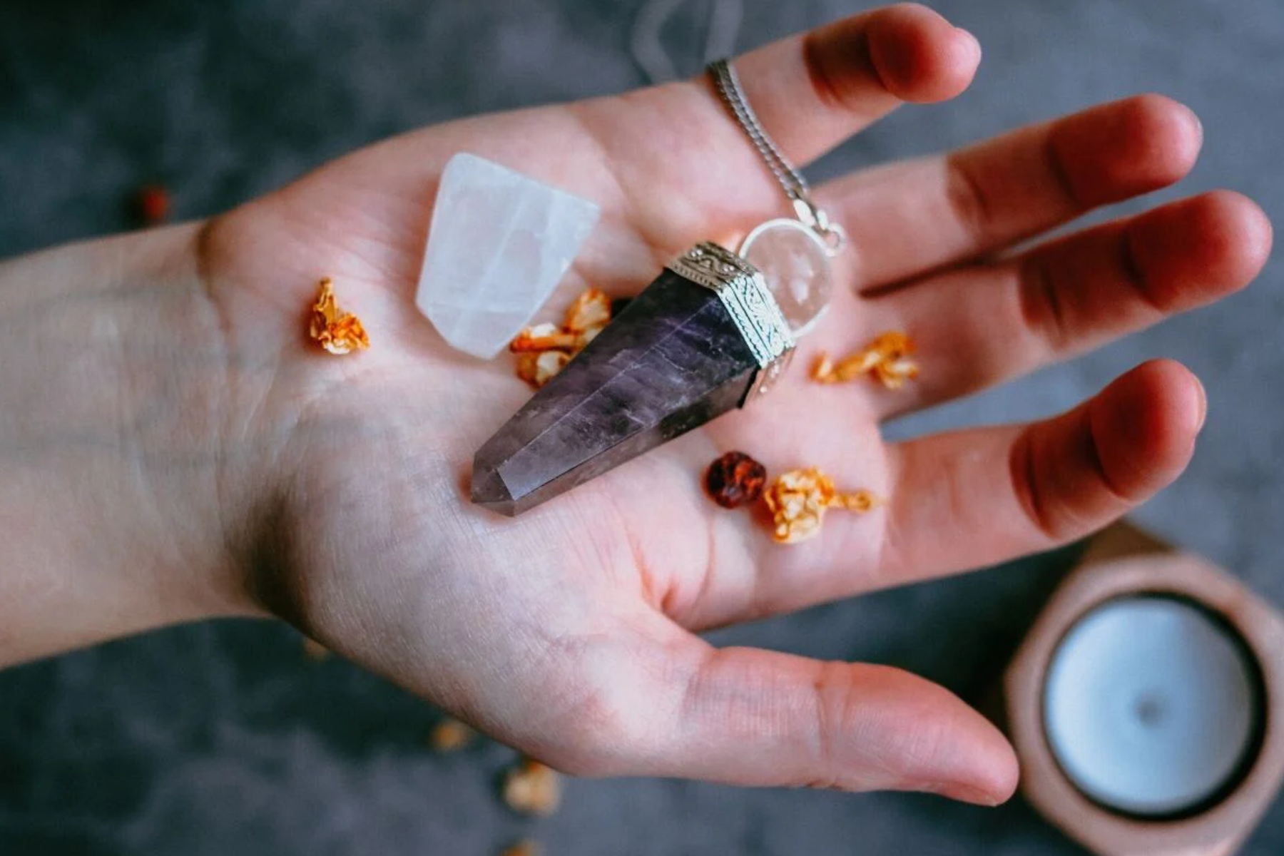 Amethyst and clear quartz in a man's palm