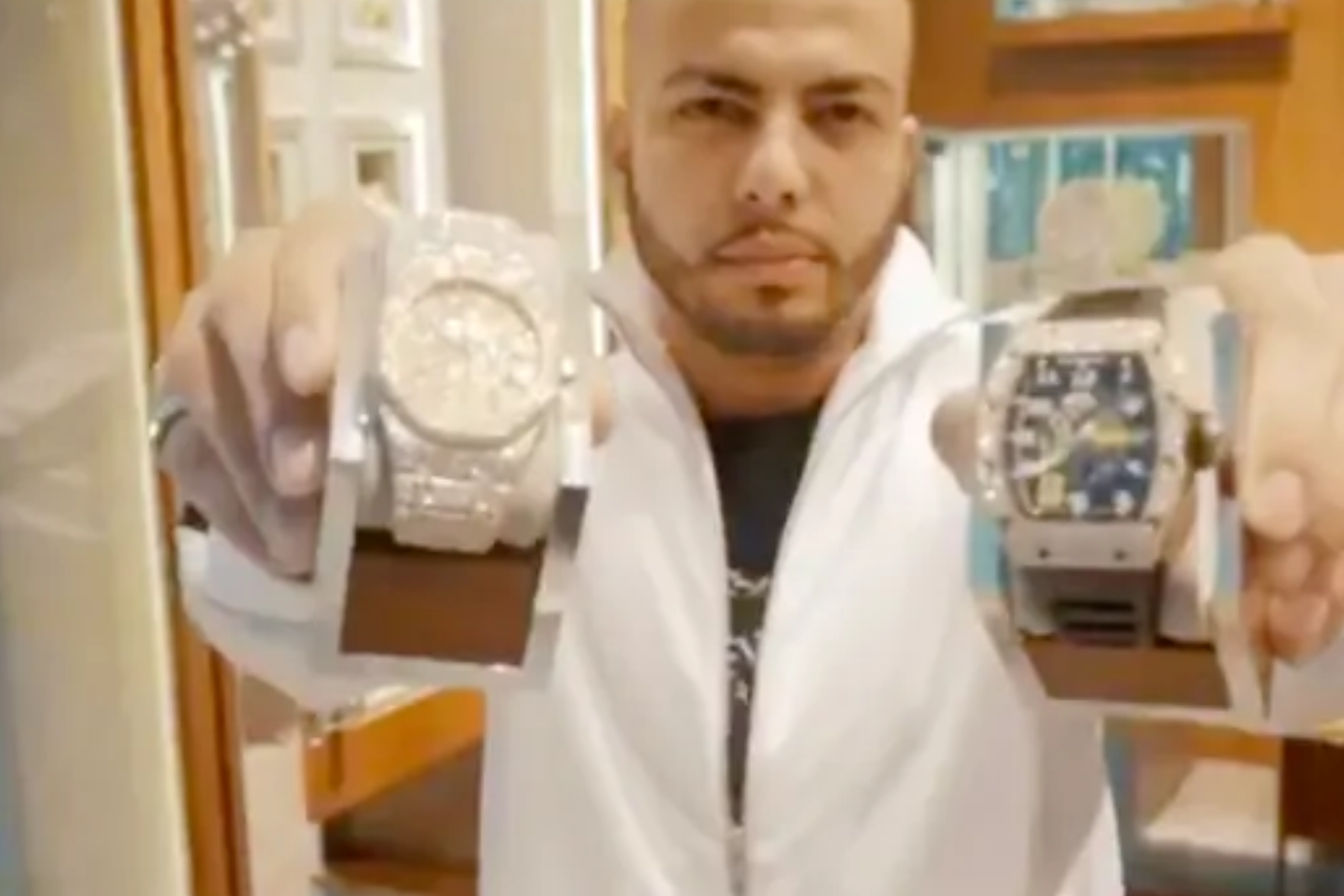 Eric Mavachev holding two luxury watches