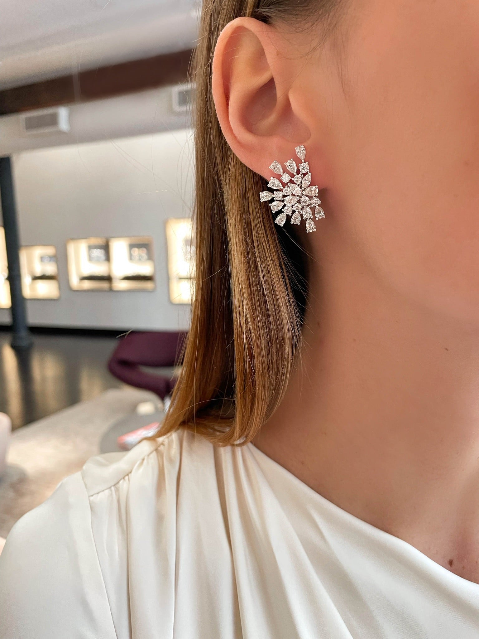 Woman Wearing Starburst Diamond Earrings