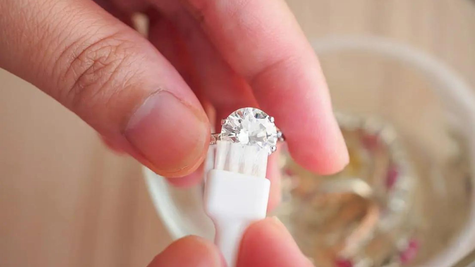 Someone Cleaning Diamond Ring With Brush