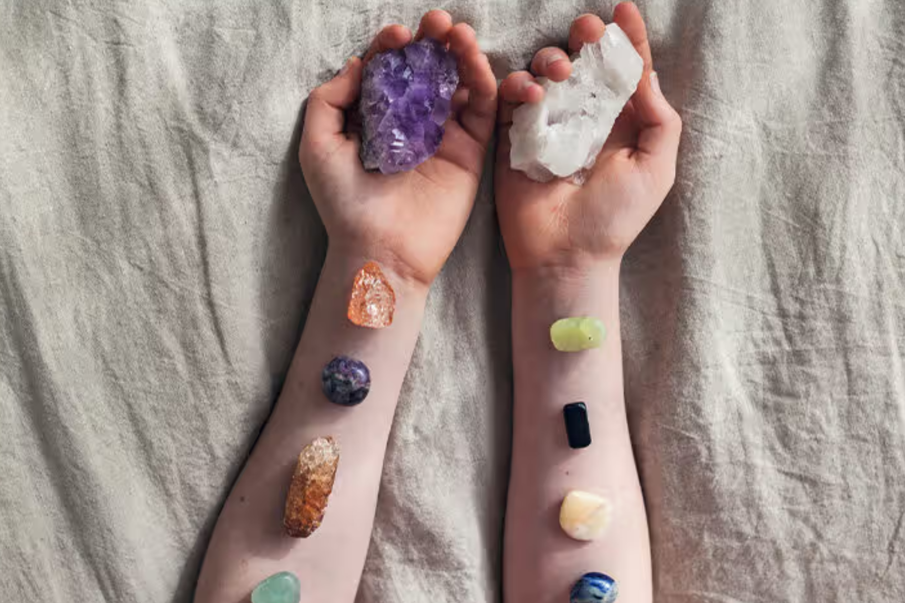 A woman's arm adorned with several types of gemstones