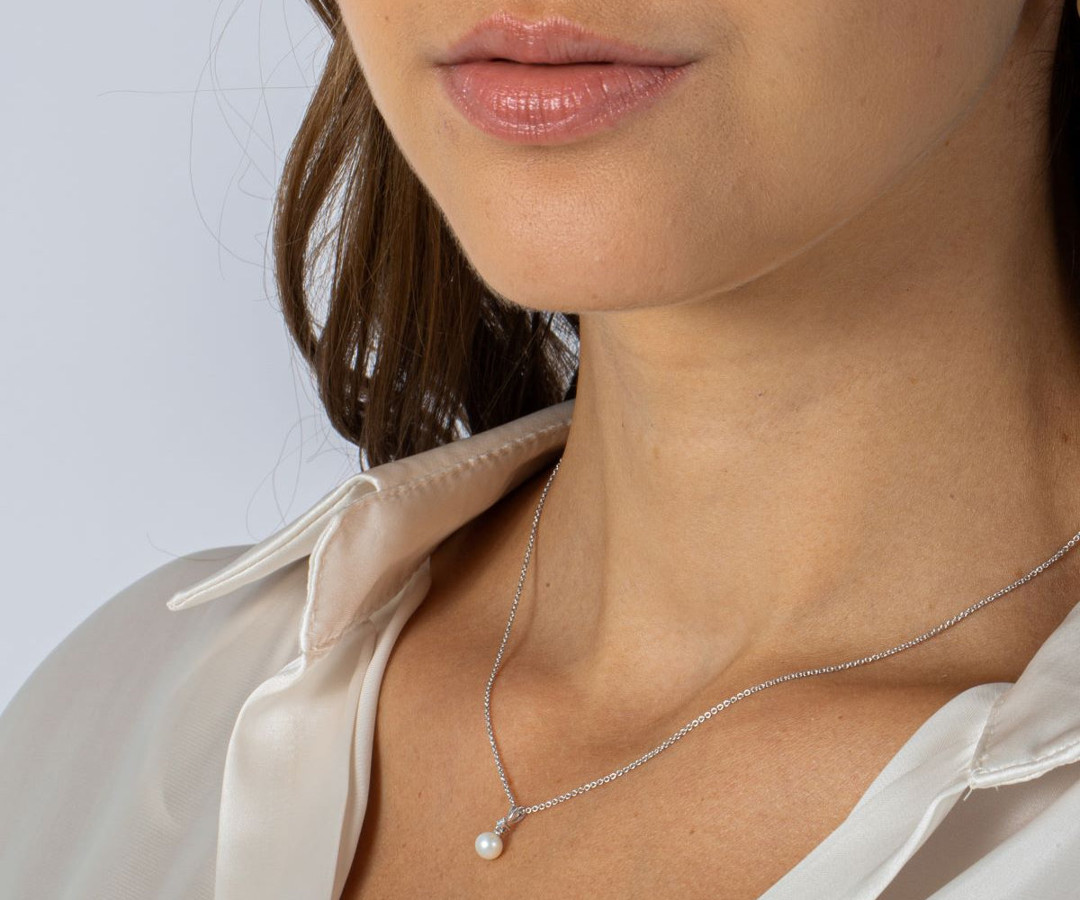 Woman Wearing Diamond and Pearl Pendant