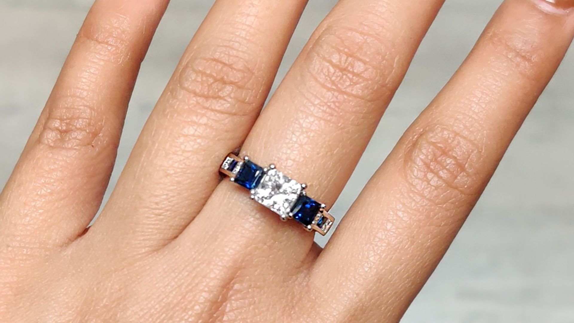 Person Wearing Trillion Cut Diamond Ring