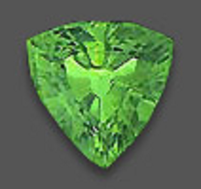A polished green sapphire shaped like an inverted triangle but with curved sides