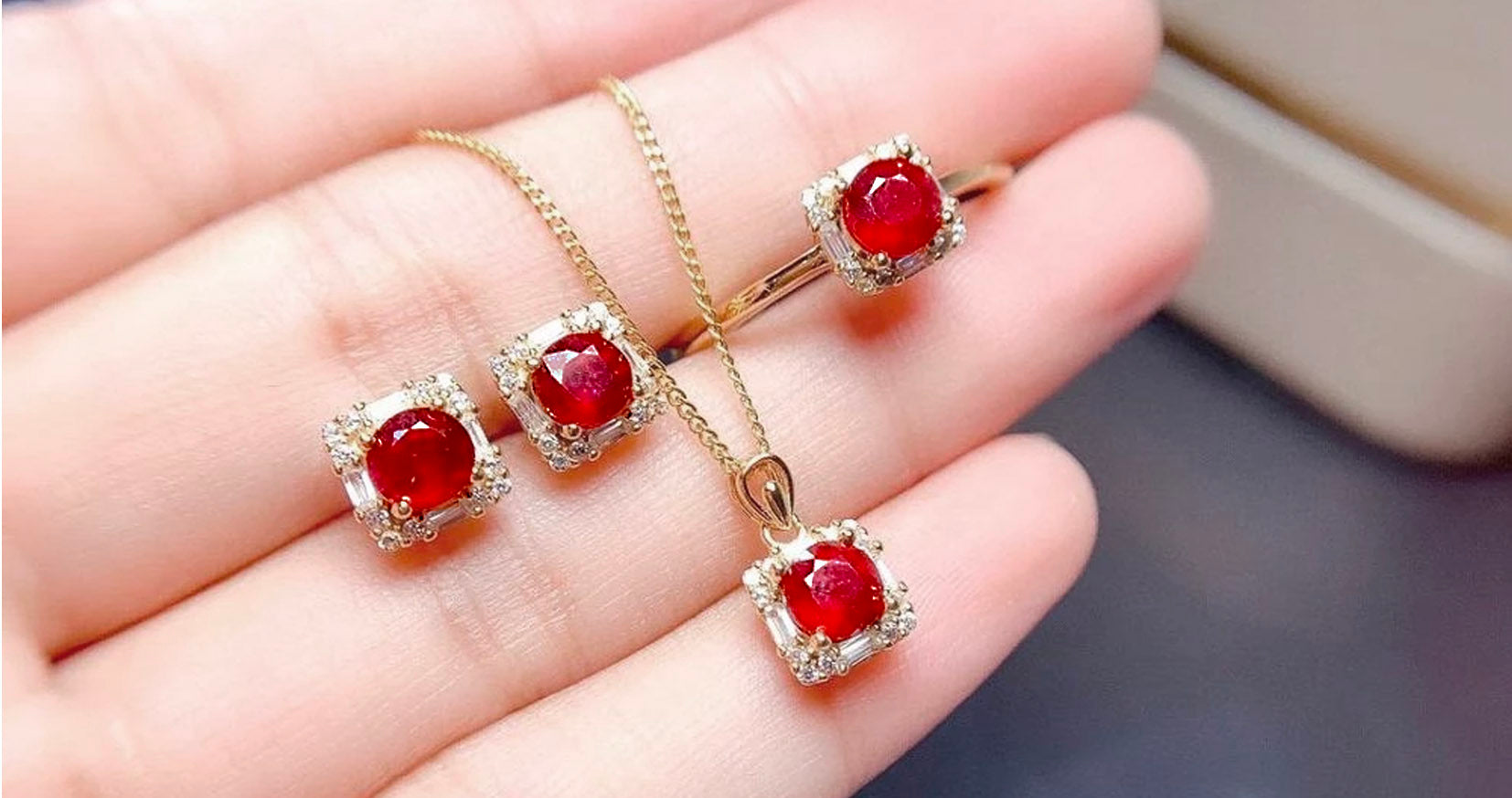 Woman Holding A Set Of Ruby Jewelry