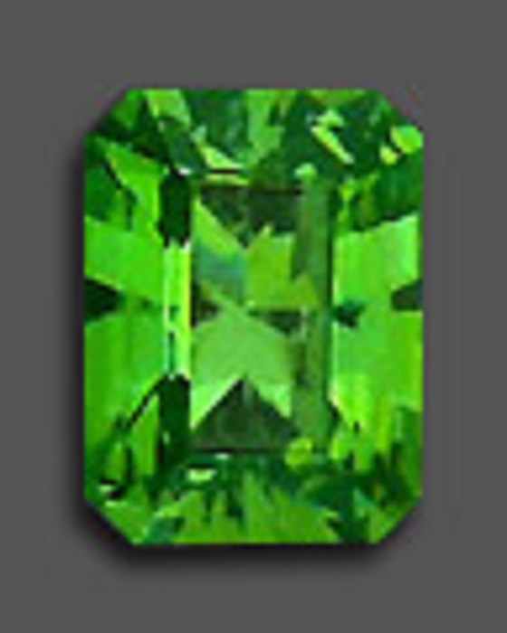 A polished rectangular green emerald