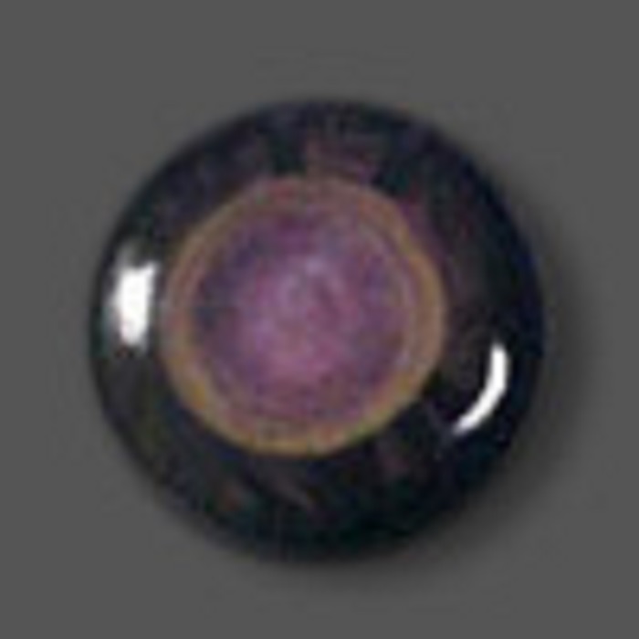 A round, shiny black rainbow obsidian, with a circular-colored part in the middle mainly in purple shade