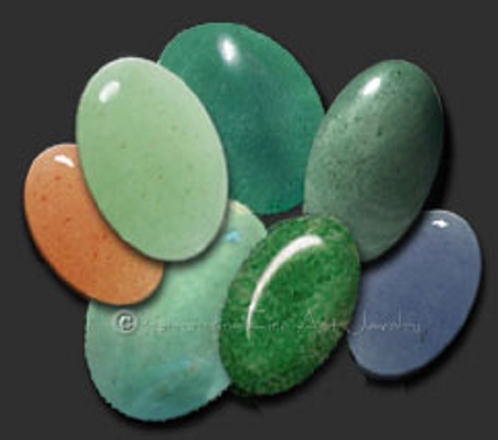 Seven pieces of polished oval-shaped aventurine gemstones in different colors, with one in green
