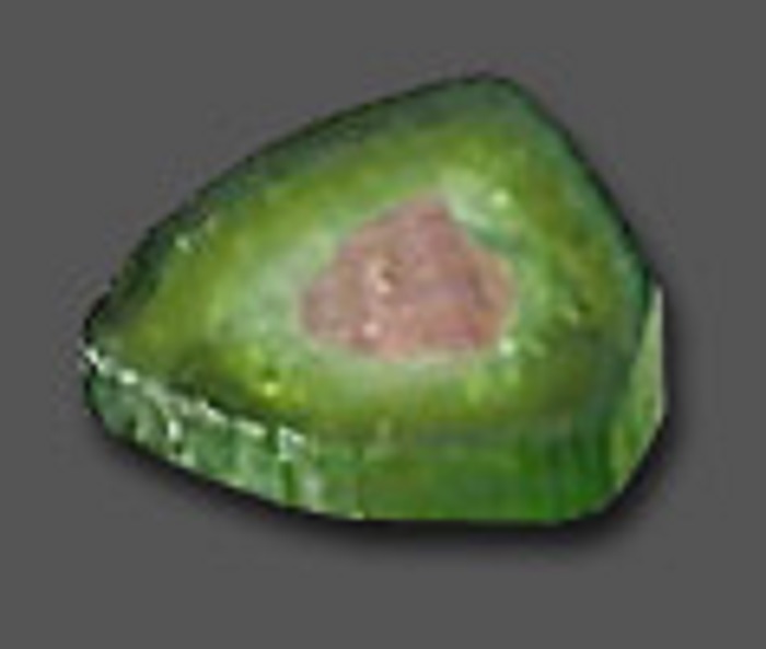 A thick flat chunk of green watermelon tourmaline, with a shade of pink in the middle