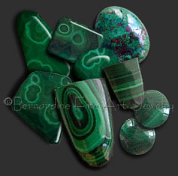 Nine pieces of differently shaped green malachite gemstones and some with patterns and shades of black