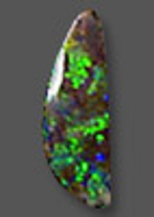 A long, almost pointed, irregularly-shaped green boulder opal