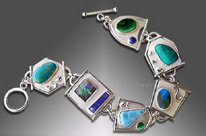 A silver five-link bracelet with malachite, larimar, chrysocolla, boulder opal and turquoise cabochons