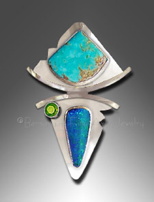 A silver pendant with a triangular turquoise with a curved base and with boulder opal and small round peridot