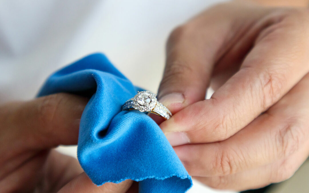 Woman Cleaning A Diamond Ring Wit Blue Towel