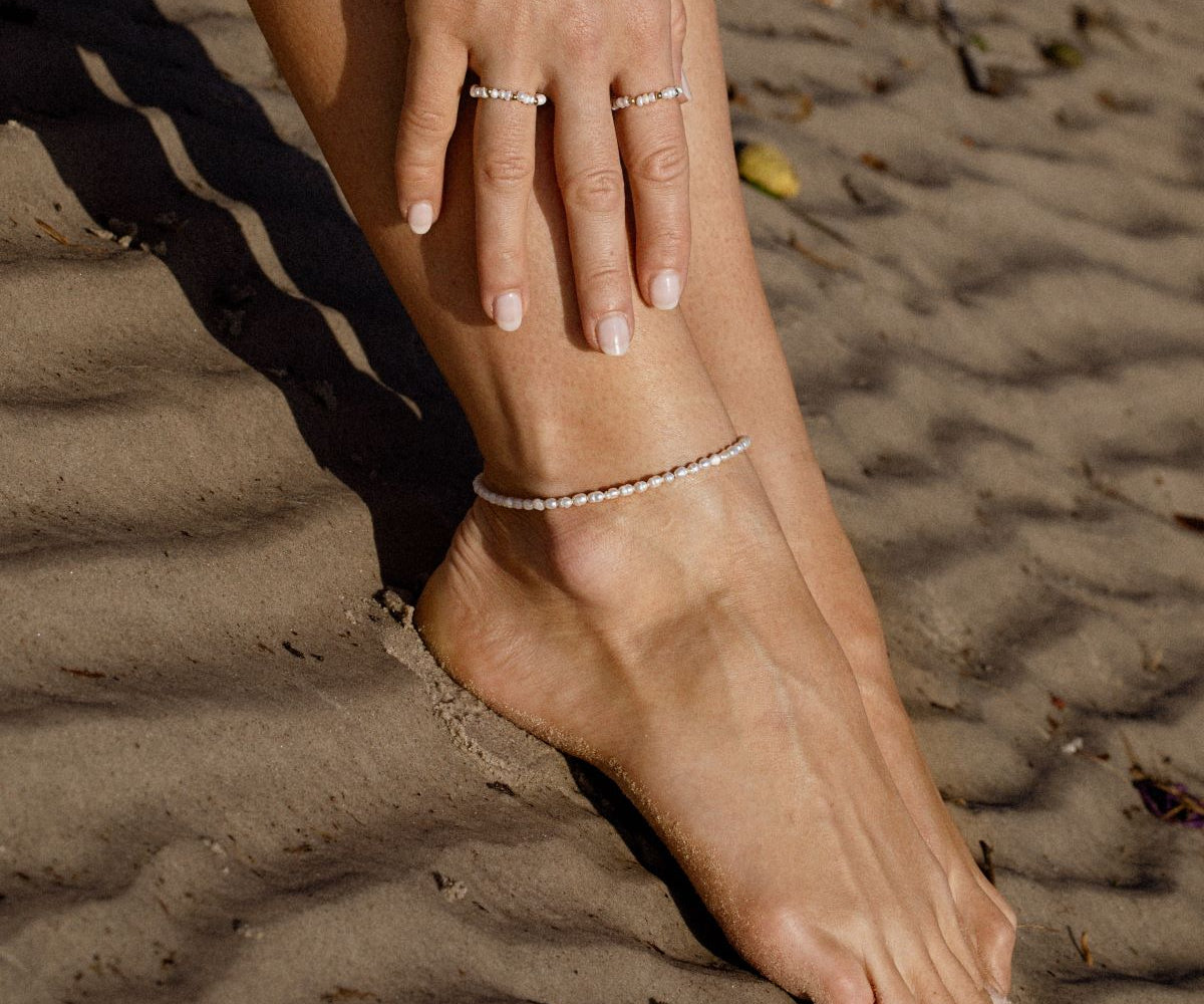 Woman Wearing Diamond And Pearls Anklet